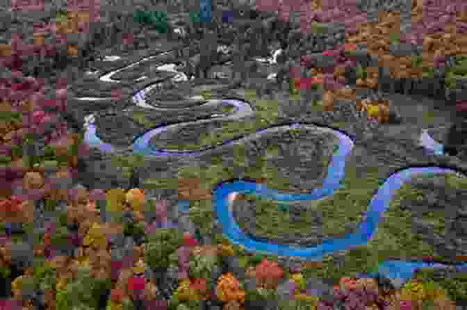 A Breathtaking Scene Of A Rugged Mountain Range With A Winding River Cutting Through Its Heart Where The Jackals Howl: And Other Stories